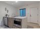 Modern kitchen featuring a marble countertop island, a stainless steel microwave, and sleek wood flooring at 1539 W Puget Ave, Phoenix, AZ 85021