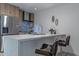 Modern kitchen featuring a stainless steel refrigerator, a marble countertop island, and stylish chairs at 1539 W Puget Ave, Phoenix, AZ 85021