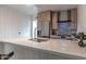 Modern kitchen featuring a stainless steel refrigerator, a marble countertop island, and white wood paneling at 1539 W Puget Ave, Phoenix, AZ 85021