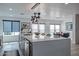 Kitchen island with white countertop, stainless steel appliances, and modern light fixtures at 1539 W Puget Ave, Phoenix, AZ 85021