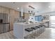 A modern kitchen features a large island, wooden cabinets, and stainless steel appliances at 1539 W Puget Ave, Phoenix, AZ 85021