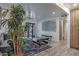 A stylish living room features modern furniture, a large plant, and a sleek black door at 1539 W Puget Ave, Phoenix, AZ 85021