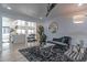 Bright living room with hardwood floors, gray couch and view to the kitchen island at 1539 W Puget Ave, Phoenix, AZ 85021