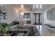 A modern living room features sleek furniture, stylish decor, and a black-framed glass door at 1539 W Puget Ave, Phoenix, AZ 85021