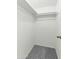 Neat closet with gray carpet flooring, white walls, and a rod for hanging clothes at 1828 W Tuckey Ln # 13, Phoenix, AZ 85015