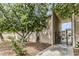 Property exterior with desert landscaping, mature shade trees, and gated entrance at 1828 W Tuckey Ln # 13, Phoenix, AZ 85015