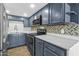 A modern kitchen showcases blue cabinets, stainless steel appliances, and stylish countertops at 1828 W Tuckey Ln # 13, Phoenix, AZ 85015