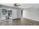 This living room has beautiful wood-look flooring, a ceiling fan, and large windows at 1828 W Tuckey Ln # 13, Phoenix, AZ 85015