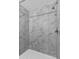 Contemporary shower with white marble-patterned tile surround and sleek chrome fixtures at 1828 W Tuckey Ln # 13, Phoenix, AZ 85015