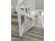 Carpeted staircase with white wood railing leading to the lower level with wood flooring at 1828 W Tuckey Ln # 13, Phoenix, AZ 85015
