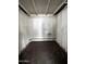 Small storage area featuring painted brick wall, minimal lighting, and concrete floor at 1828 W Tuckey Ln # 13, Phoenix, AZ 85015