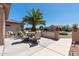 An inviting back patio features a dining set and desert landscaping, ideal for outdoor enjoyment at 20394 N Coronado Way, Surprise, AZ 85374