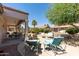 Inviting backyard with covered patio, stylish outdoor furniture, and well-maintained landscaping at 20394 N Coronado Way, Surprise, AZ 85374