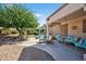 Spacious backyard with a covered patio, featuring comfortable seating and a relaxing ambiance for outdoor gatherings at 20394 N Coronado Way, Surprise, AZ 85374