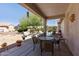 Spacious backyard featuring a covered patio, outdoor seating, and beautiful desert landscaping at 20394 N Coronado Way, Surprise, AZ 85374