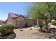 Picture of a well landscaped backyard, complete with desert landscaping and solar panels on the roof at 20394 N Coronado Way, Surprise, AZ 85374