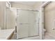 Bathroom featuring a shower with glass sliding doors, and a toilet in a separate room at 20394 N Coronado Way, Surprise, AZ 85374
