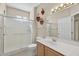 Bathroom featuring a glass door shower, cabinets, and decorations at 20394 N Coronado Way, Surprise, AZ 85374
