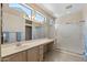 Bathroom featuring high windows, vanity with ample lighting, an enclosed shower, and neutral tones at 20394 N Coronado Way, Surprise, AZ 85374