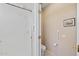 Shower area featuring white tiled walls, glass doors, and an easily accessible toilet with safety bar at 20394 N Coronado Way, Surprise, AZ 85374