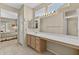 Bathroom with a large mirror, vanity, cabinets, and a view to the bedroom at 20394 N Coronado Way, Surprise, AZ 85374