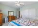 Bright bedroom featuring a bed with a colorful quilt, sliding closet doors, and ample space at 20394 N Coronado Way, Surprise, AZ 85374