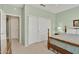 Bedroom featuring closet doors, carpet flooring, and light green walls at 20394 N Coronado Way, Surprise, AZ 85374