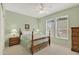 Bedroom featuring two windows, wooden furniture, and light green walls at 20394 N Coronado Way, Surprise, AZ 85374