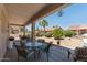 Serene covered patio with outdoor dining, decorative elements, and a view of the desert landscape at 20394 N Coronado Way, Surprise, AZ 85374