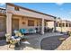 Enjoy the covered patio's seating, perfect for relaxing or entertaining in this well-appointed outdoor living space at 20394 N Coronado Way, Surprise, AZ 85374