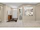 Open-concept entryway with tile flooring, neutral walls, and a glimpse into the living area and home office at 20394 N Coronado Way, Surprise, AZ 85374