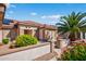 Well-maintained home with a tiled roof, desert landscaping, privacy wall and vibrant flowers surrounding the property at 20394 N Coronado Way, Surprise, AZ 85374