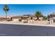 View of charming one-story home with tile roof, desert landscaping, and attached garage, offering curb appeal at 20394 N Coronado Way, Surprise, AZ 85374