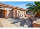 Home exterior featuring palm tree shadow on the patio, and an inviting outdoor living space at 20394 N Coronado Way, Surprise, AZ 85374