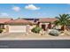 Charming single-story home featuring a tile roof, desert landscaping, and a two-car garage in a sunny neighborhood at 20394 N Coronado Way, Surprise, AZ 85374