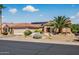 Beautiful one-story home with desert landscaping, a terracotta-colored roof, and solar panels for energy efficiency at 20394 N Coronado Way, Surprise, AZ 85374