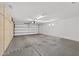Garage with epoxy flooring, lots of storage cabinets, and a roll up door at 20394 N Coronado Way, Surprise, AZ 85374