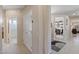Hallway that features a doorway to the bathroom, and view into the living room with furnishings at 20394 N Coronado Way, Surprise, AZ 85374