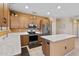Bright kitchen featuring modern appliances, wooden cabinetry, island with quartz countertops, and tile flooring at 20394 N Coronado Way, Surprise, AZ 85374
