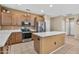 Bright kitchen featuring stainless steel appliances and a functional center island for meal preparation at 20394 N Coronado Way, Surprise, AZ 85374