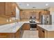 Stylish kitchen with stainless steel appliances, bright counter tops, and ample cabinet storage at 20394 N Coronado Way, Surprise, AZ 85374