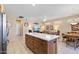 Bright and open floor plan, seamlessly blending living room with eat-in kitchen and island with quartz countertops at 20394 N Coronado Way, Surprise, AZ 85374