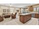 Open floor plan with kitchen island and dining area flowing into the living room at 20394 N Coronado Way, Surprise, AZ 85374