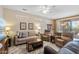 Cozy living area with neutral tones, plush seating, bright natural light, and access to the backyard at 20394 N Coronado Way, Surprise, AZ 85374