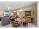 Inviting living room with round dining table, comfortable seating, neutral tones, and bright natural light at 20394 N Coronado Way, Surprise, AZ 85374