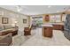 Open floor plan with kitchen island and dining area flowing into the living room at 20394 N Coronado Way, Surprise, AZ 85374