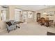 Inviting living room with an open layout, plush chair, and view of dining area at 20394 N Coronado Way, Surprise, AZ 85374