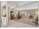 Open concept living room with bright windows, plush seating, and a decorative hutch at 20394 N Coronado Way, Surprise, AZ 85374