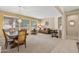 Cozy living room featuring neutral tones, large windows, and comfortable seating arrangements at 20394 N Coronado Way, Surprise, AZ 85374