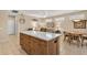 Open living area with kitchen island and dining, perfect for entertaining guests in this well-appointed home at 20394 N Coronado Way, Surprise, AZ 85374